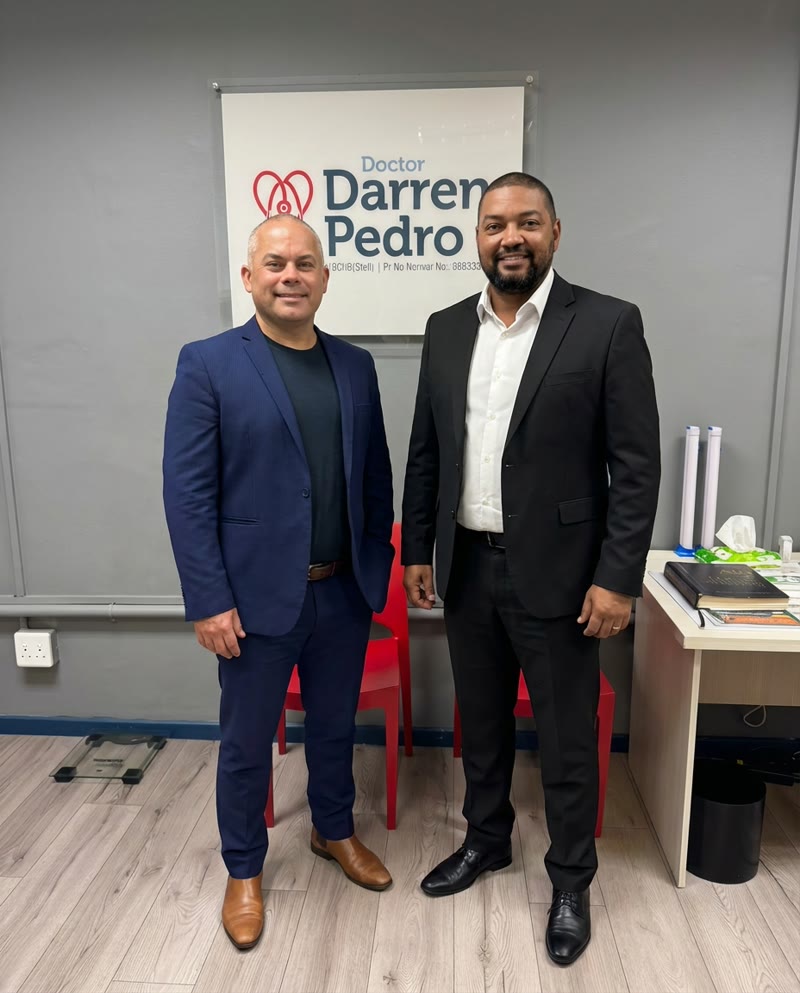Dr. Pedro and Dr. Adams in professional suits